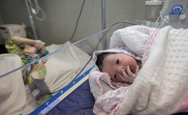 At just 30 minutes old baby Nisreen is delivered in the Al Awda hospital in Gaza city during the eighth day of the current conflict
