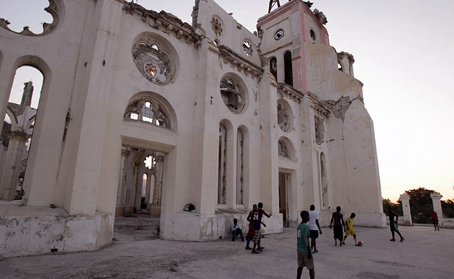 Children play football in the ruins of Notre Dame Cathedral, Port-au-Prince