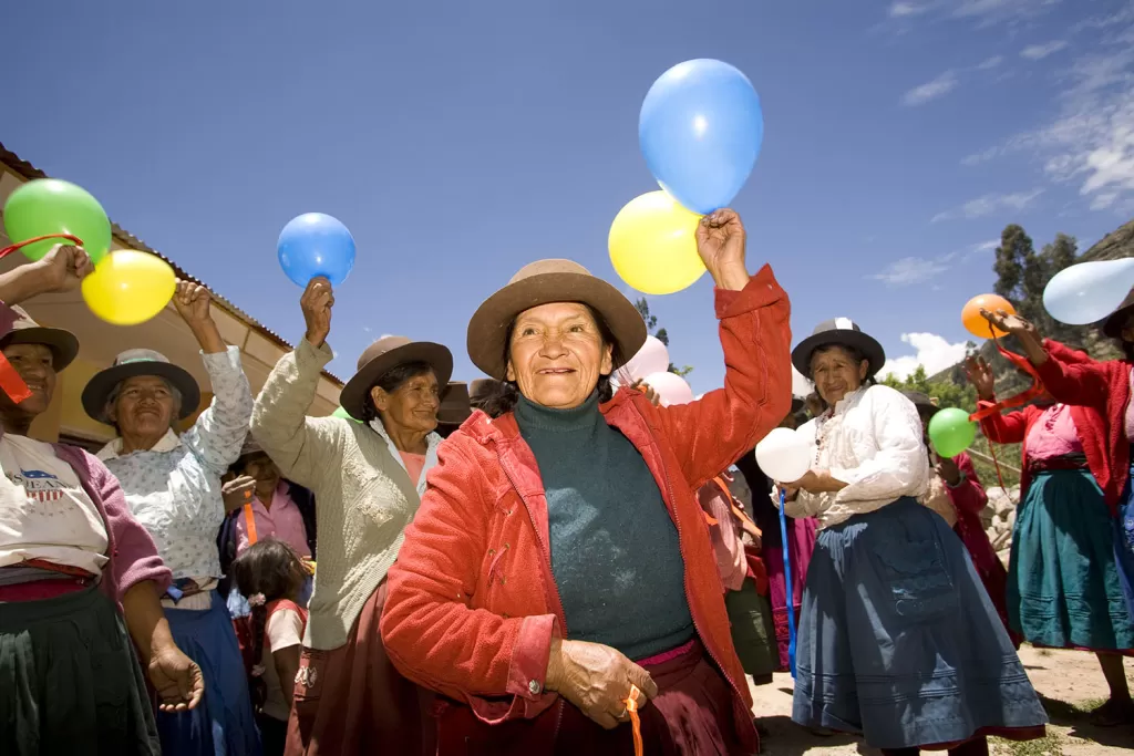 older women hold balloons