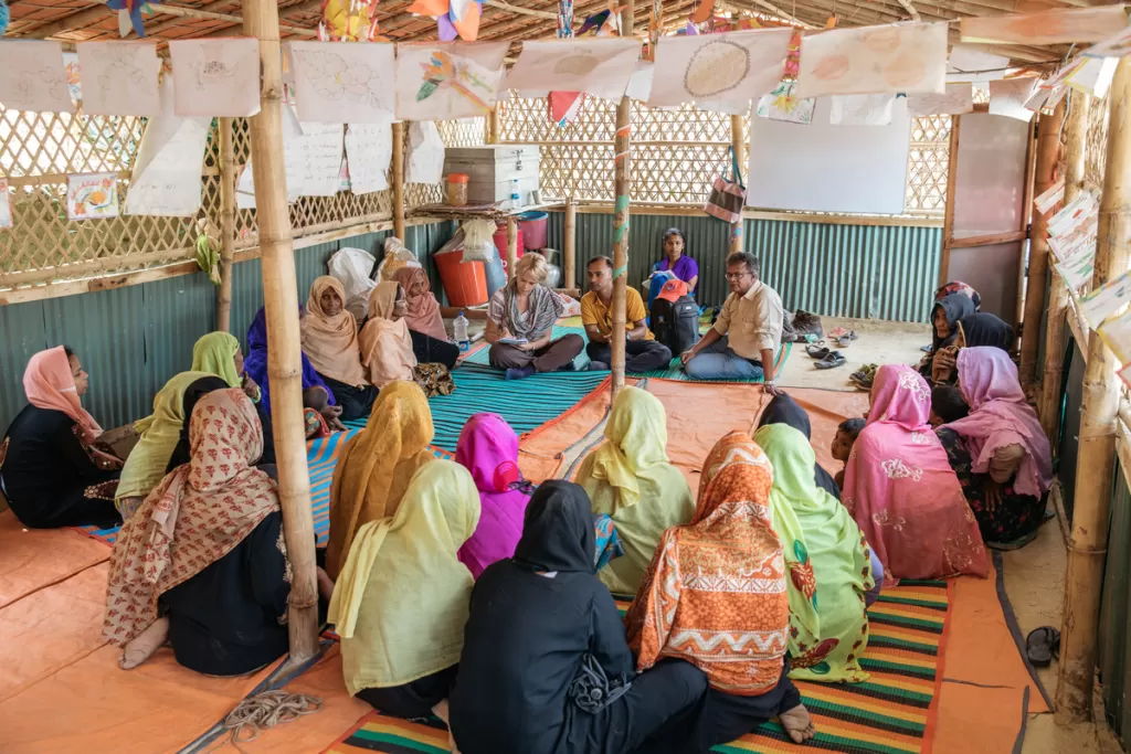Women sit in a circle at a women-friendly space