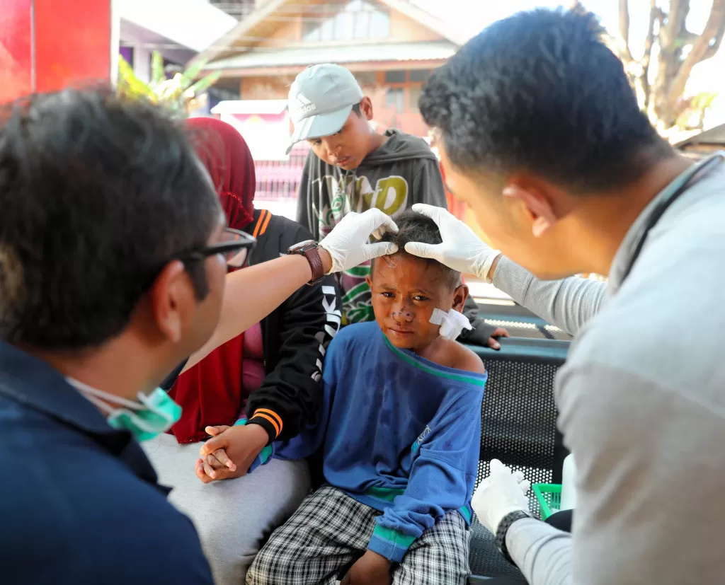 A boy receives treatment following the earthquake