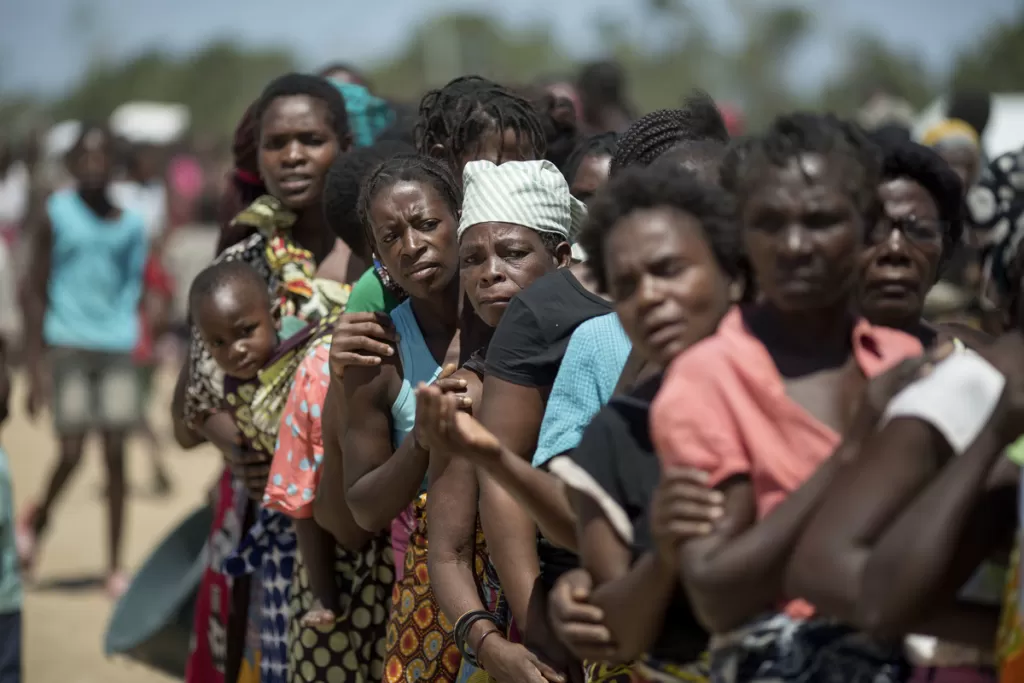 Women wait in line at an aid distribution by CARE in Dondo District, Mozambique after Cyclone Idai.