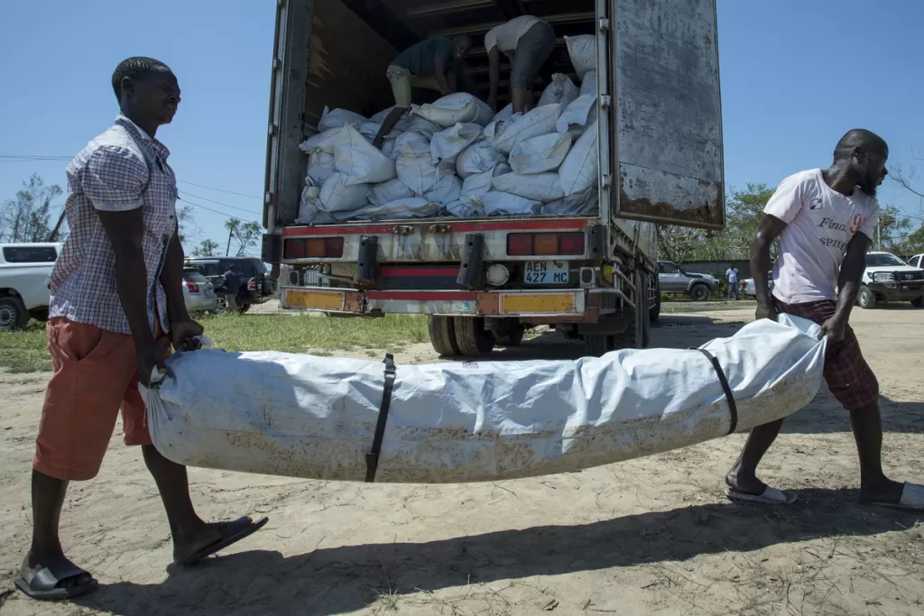 Emergency shelter kits are unloaded from a truck near Beira, Mozambique, following Cyclone Idai.
