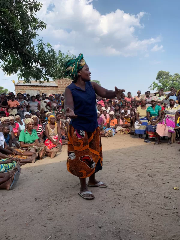 A member of the community speaks at a meeting at the women's centre set up by ActionAid using DEC funds.