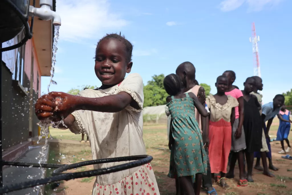 Sarah, 6, learns proper hand-washing in South Sudan. 