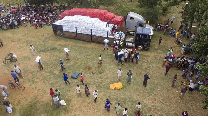 People collect food aid at a distribution in Malawi