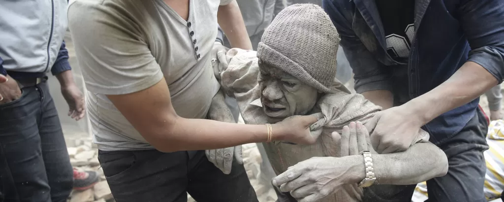 A man is pulled from rubble after the earthquake