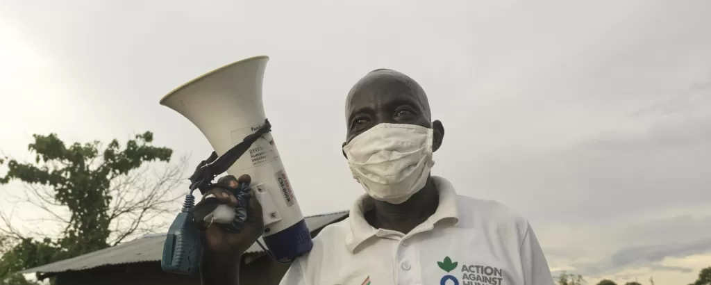 An aid worker carries a megaphone