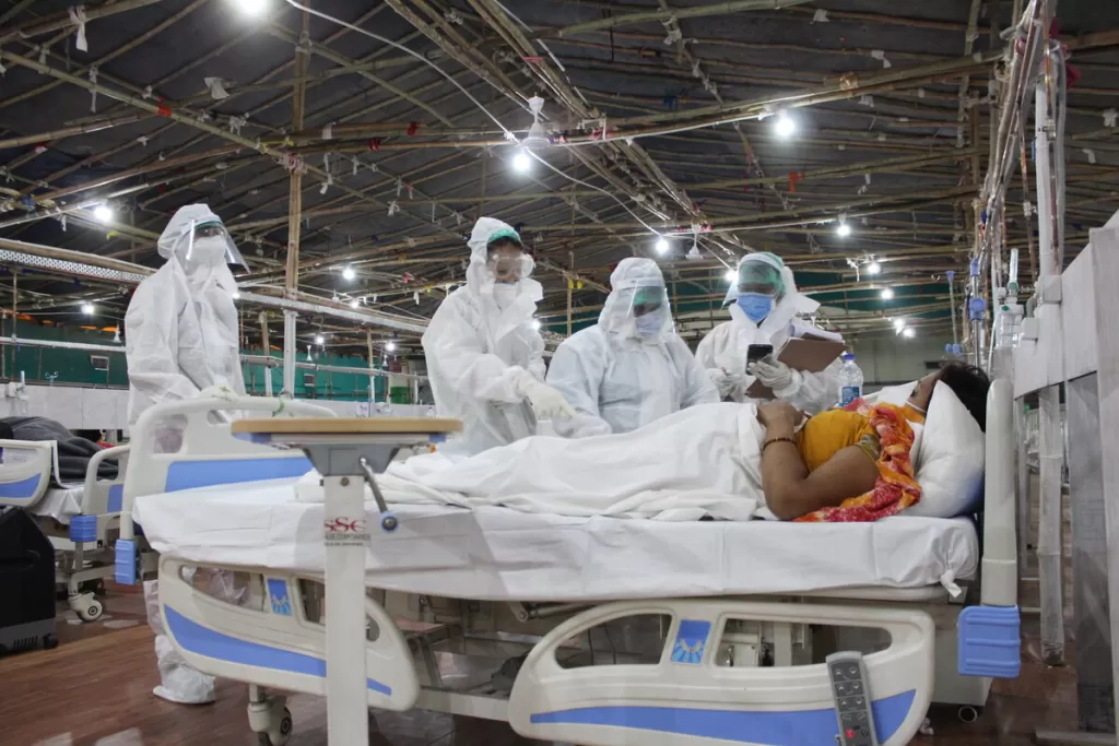 Medical staff care for a patient in a ward in a sports centre