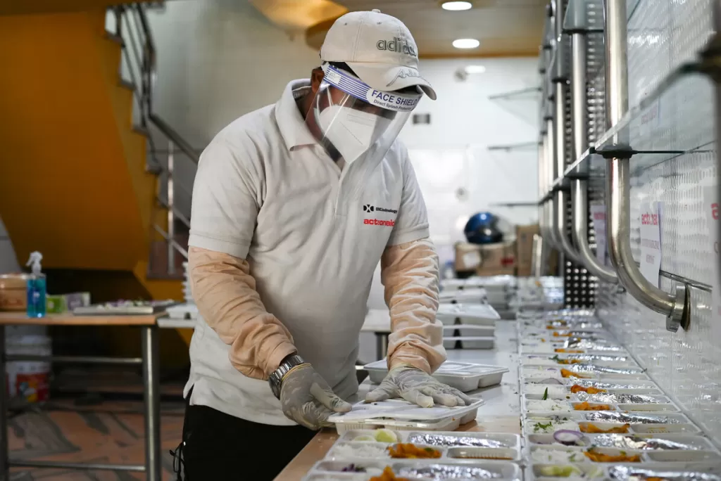 A volunteer prepares food packages