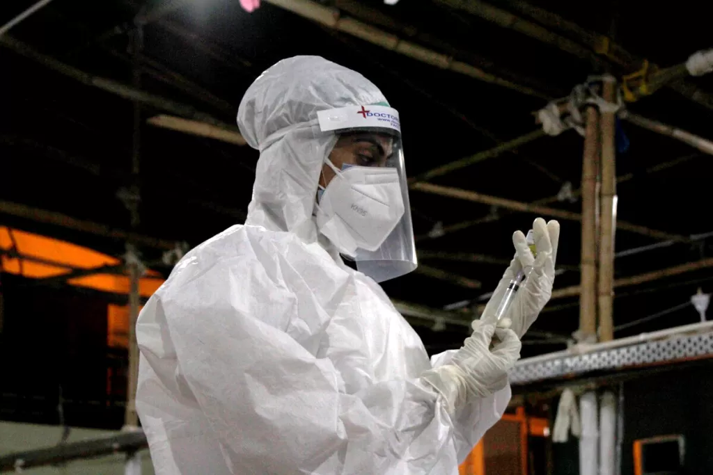 A medic prepares an injection at a medical centre in india