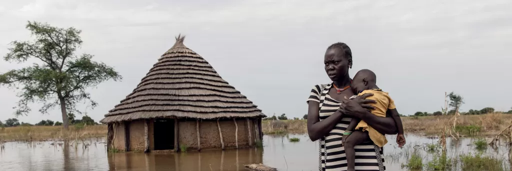 International Rescue Committee photo from South Sudan of lady holding baby in floods