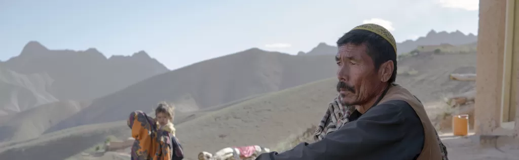 Abdul-Karim* sits in front of his house in Daykundi Province, Afghanistan.