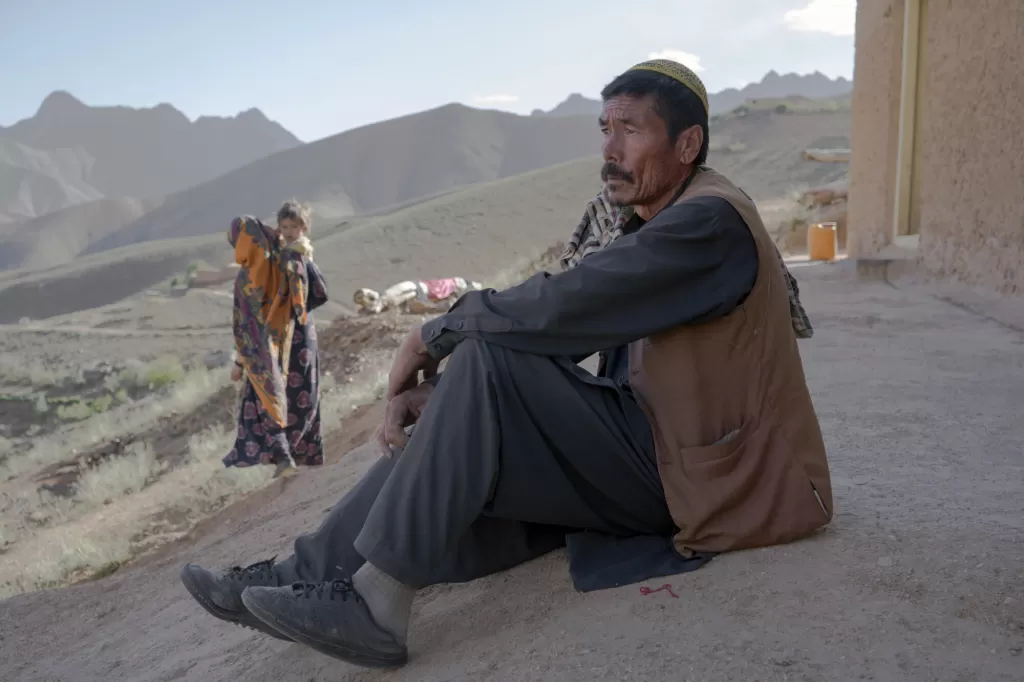Abdul-Karim* sits in front of his house in Daykundi Province, Afghanistan.