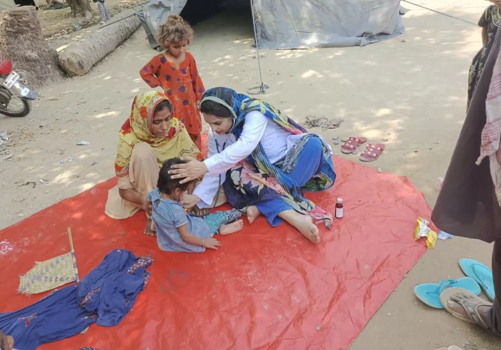 Dr. Abeer treating children at a camp