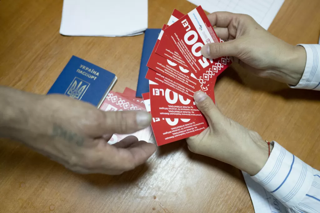 An older refugee in Moldova receives vouchers