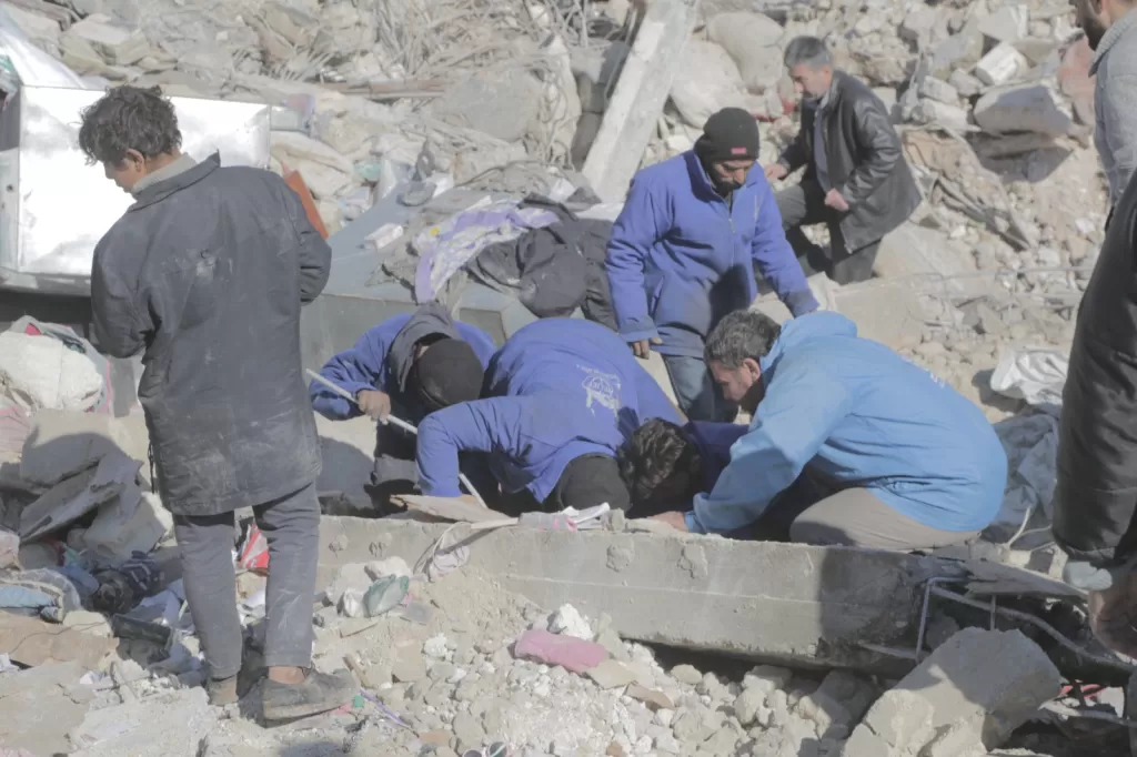 Islamic Relief aid workers amidst the rubble