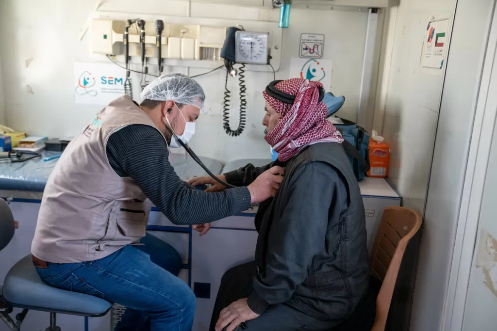 A doctor from SEMA checks a patient in a mobile clinic in Syria