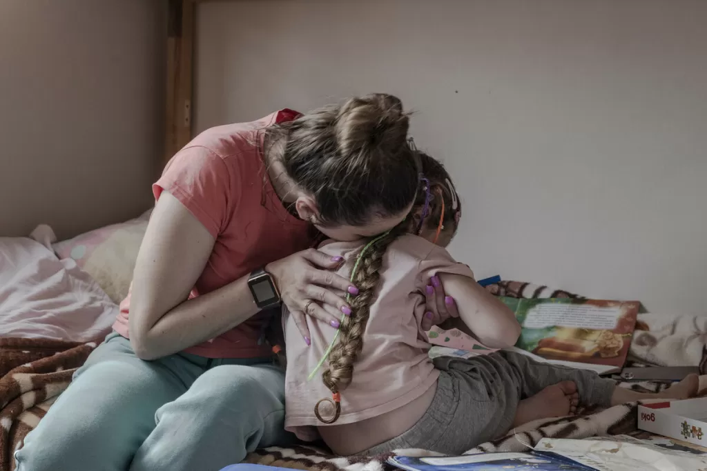 Oksana* and her daughter Galyna* together in their room in a shelter in Lviv