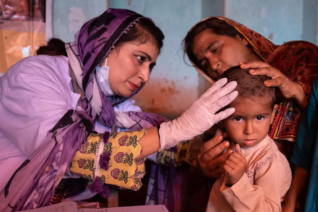 Dr Saiqa checking a child at the mobile health unit