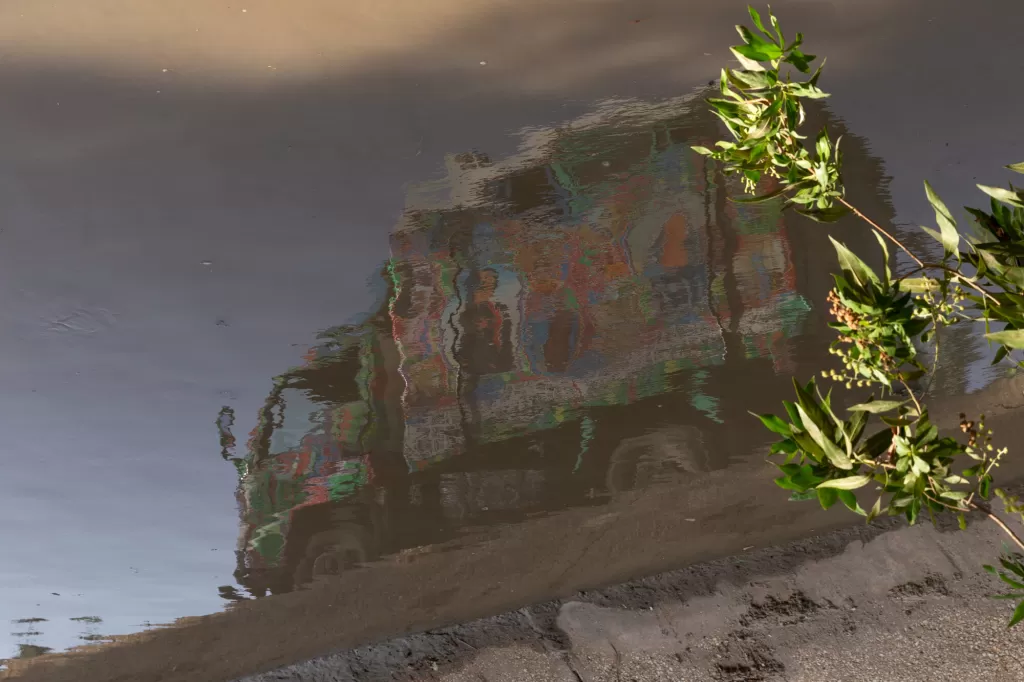 Reflection of the painted truck in water