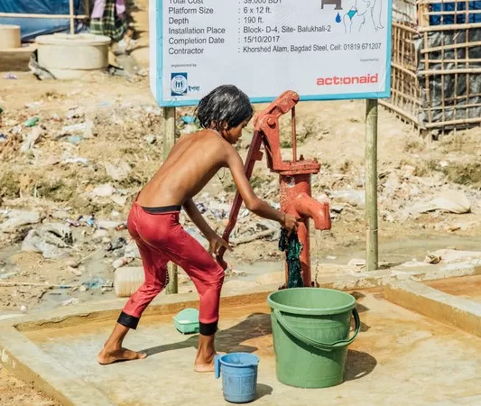 A child uses a water pump funded by ActionAid in the refugee camps near Cox's Bazar.