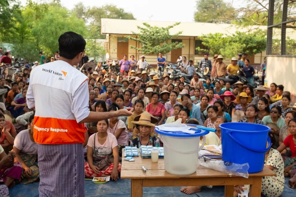 Man gives demo on water purification to crowd in Myanmar 