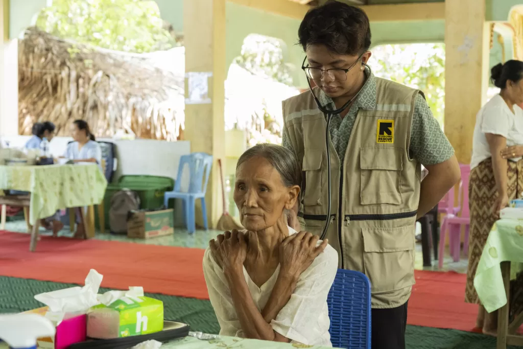 An elderly women receives treatment in Myanmar from a mobile health clinic 