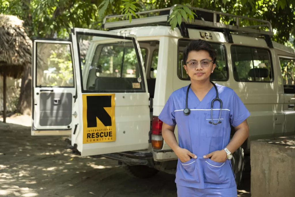 A doctor poses by a mobile health clinic in Myanmar 