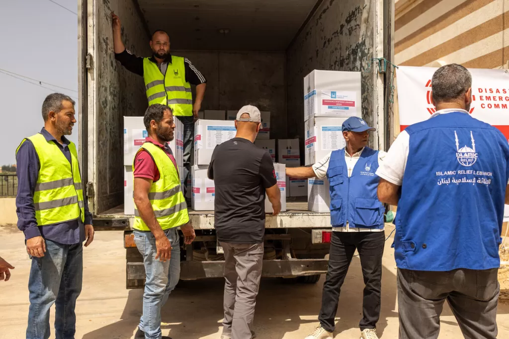 AId workers take aid off the back of a truck in Lebanon 
