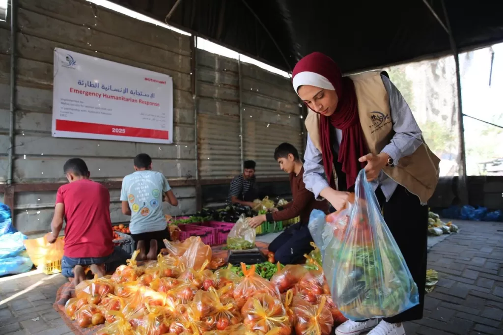 DEC charity ActionAid's local partner in Gaza, Wefaq Society for Women and Child Care, carry out a delivery of DEC funded fresh vegetables in food packages, 4 May 2025.