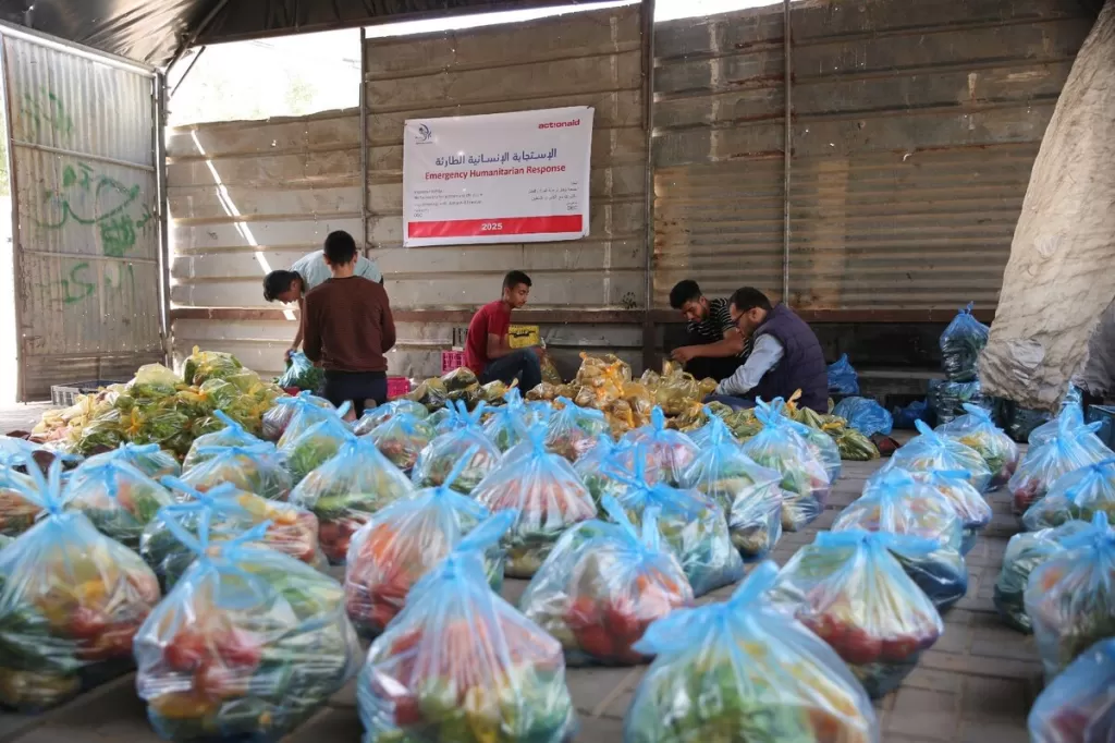 DEC charity ActionAid's local partner in Gaza, Wefaq Society for Women and Child Care, carry out a delivery of DEC funded fresh vegetables in food packages, 4 May 2025.