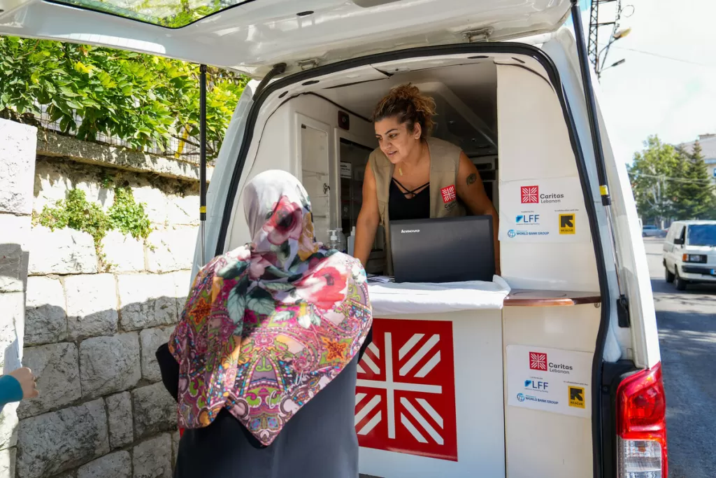 Jannette, the head nurse of a mobile care unit run by Caritas Lebanon, works from her van outside a school converted into a shelter in central Lebanon, 18 October 2024. Image: Elisa Oddone