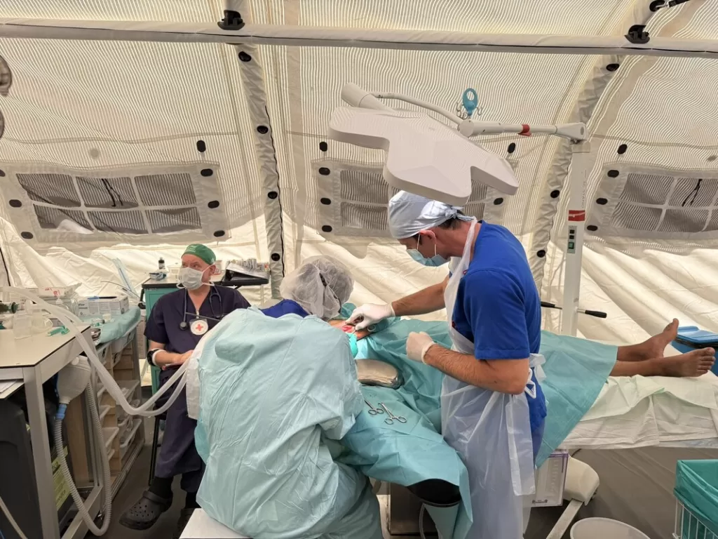 Surgeons operating in a field hospital in Gaza