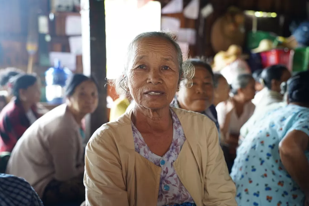 Daw Than Yin, 69, attends a multipurpose cash distribution event for earthquake-affected communities in her village in Inle Lake, Myanmar, 26 June 2025.