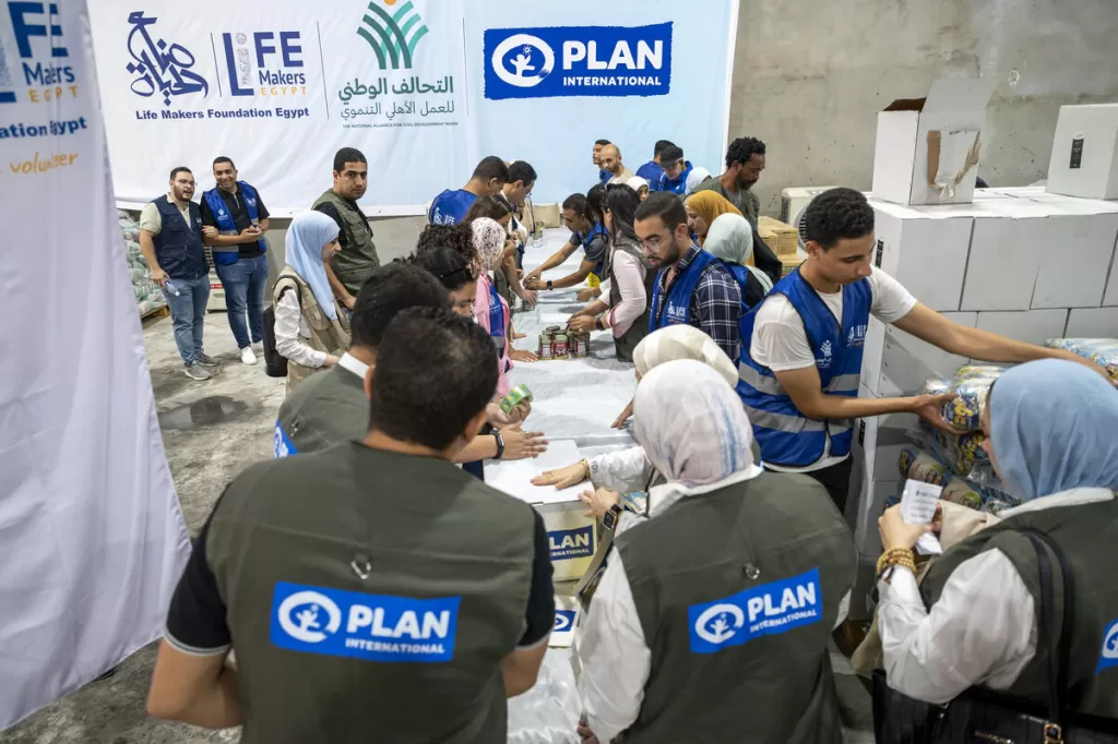 Plan International aid workers pack trucks bound for Gaza. October 2025