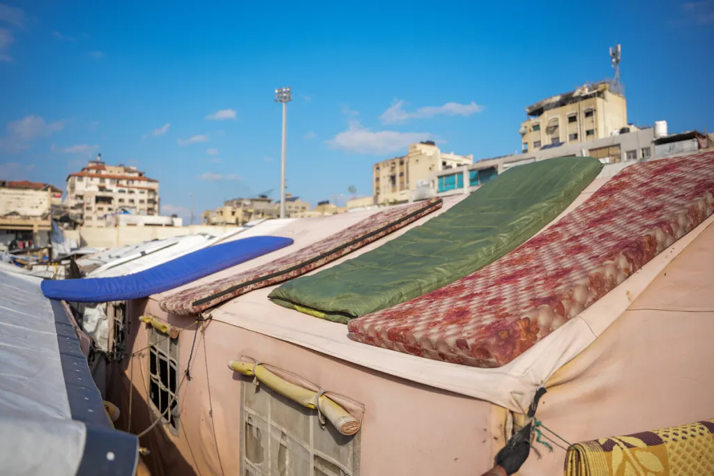Bedding dries on the roofs of tents in a displacement camp in Gaza.