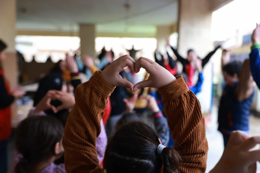 Child makes a heart with her hands in Lebanon 