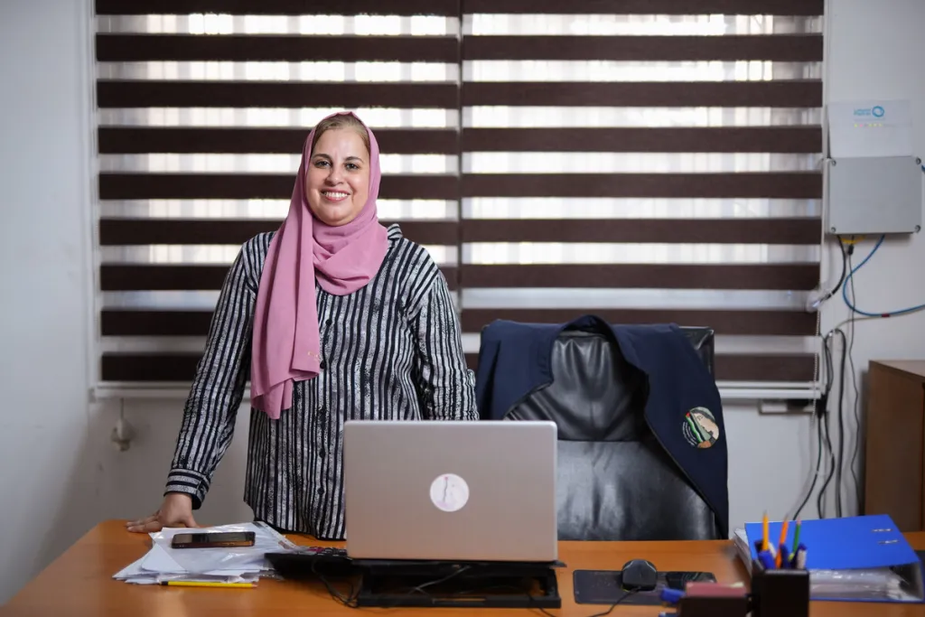 Sahar, Director of PDWSA, a local partner of DEC member charity ActionAid in Gaza, at her desk. 27 July 2026. Image: Abood ​Al ​Sayd/​Arete/​DEC 