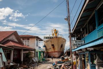 A ship washed ashore by a tsunami sits in the street
