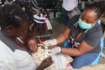 Farida is checked for malnutrition by a World Vision aid worker in South Sudan.
