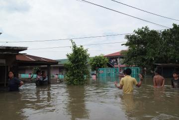 People wade through water