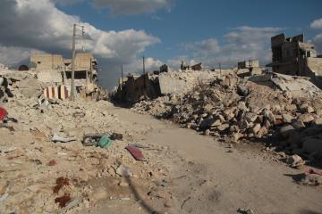 A path through rubble and destroyed buildings