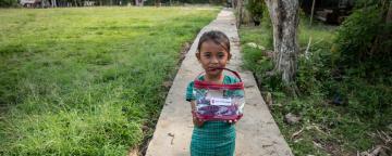 A girl holds a hygiene kit