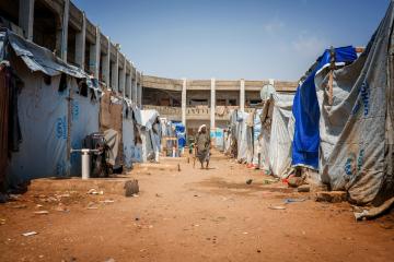 A man walks between makeshift shelters in Yemen