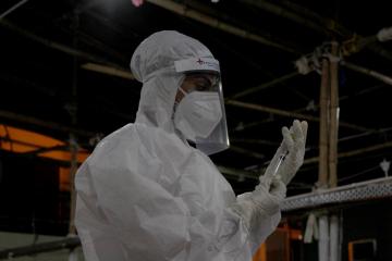 A medic prepares an injection at a medical centre in india