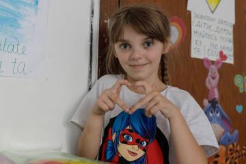 Sofia, aged 7, with her artwork at the temporary hotel accommodation in Bucharest, Romania, provided to refugees from Ukraine by DEC charity CAFOD and their partner JRS
