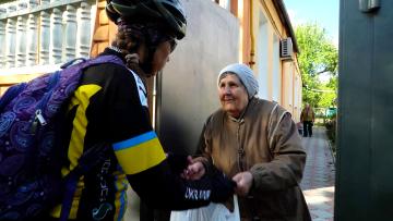 Cyclist Viktoria is one of the volunteers who delivers aid to housebound people in Kharkiv