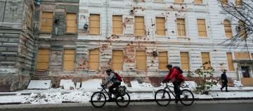 Viktoria* (L) and Oleh (R) cycle in winter conditions through Kharkiv, Ukraine on 18 November 2022.