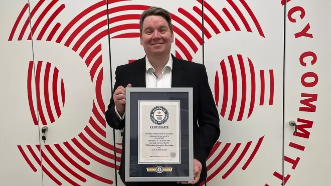 Simon Beresford Director of Fundraising and Marketing at the DEC holds the award certificate